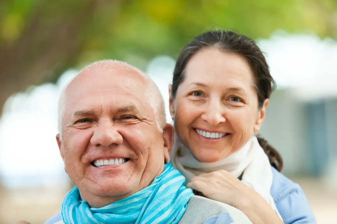 Happy senior couple outdoors with confident smiles
